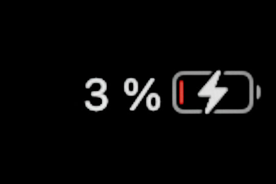 Low level of smartphone charged battery level indicator - charging process - three, 3 percent: close up macro view of gadget display, screen. Energy, technology, power, digital and symbol concept