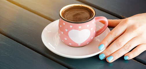 Woman holding warm mug with fresh coffee