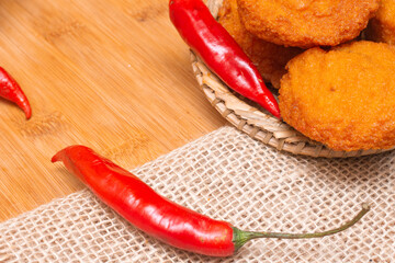 typical food from Bahia called acarajé surrounded by red peppers
