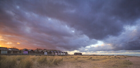 clouds over beach huts