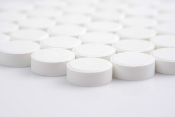 Many white medical pills close up. Pharmaceutical Industry and medicine concept. 