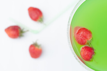Colorful bright green cocktail cactus with strawberries, delicious refreshing