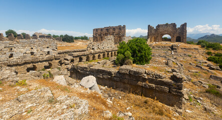 Fototapeta na wymiar View of the ancient ruins of the roman bazilica and nymphaeum in the antiquity city of Aspendos, currently located near ..Antalya in the Serik district, Turkey