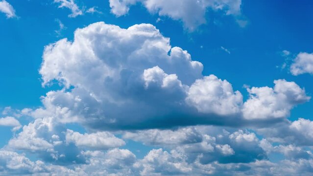 Timelapse of cumulus clouds moving in the blue sky. Fluffy clouds change their shape in cloud space. Awesome sky. Dramatic atmosphere background, time lapse. Copy space. Change of weather. Nature. 4K