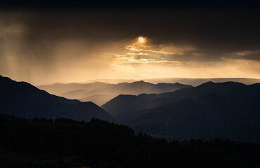 banner of mountain peaks in beautiful stormy sunset light