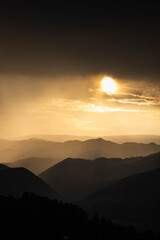 banner of mountain peaks in beautiful stormy sunset light