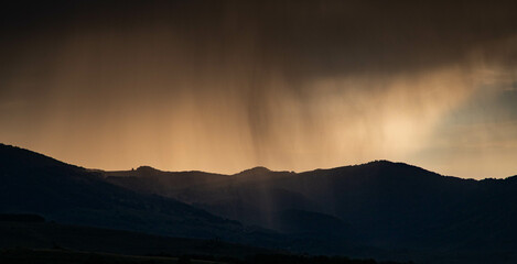 banner of mountain peaks in beautiful stormy sunset light