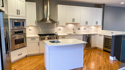 white cabinet with modern interior kitchen design, wood floors and backsplash tiles