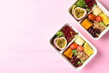 Fresh vegetables salad in biodegradable bowl on pink background, Healthy vegan food
