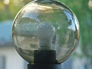 Close-up, street lamp against green, daytime shot. off city lamp in the park