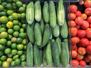 Fresh vegetables farmer market sell cucumber, tomato and lime. Healthy eating. Variety of organic vegetable.