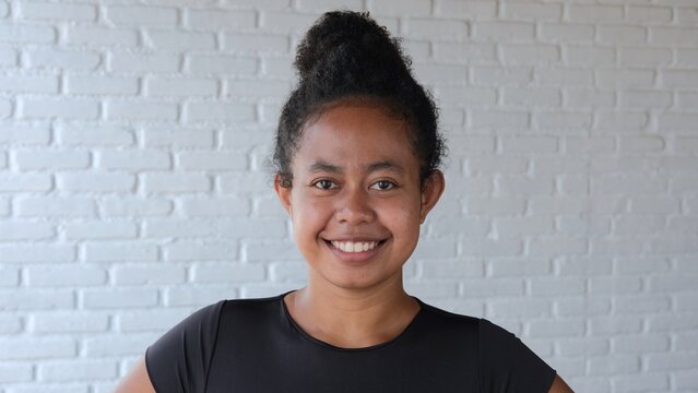 A cute black woman smiled sweetly. She has an emotional lift, which in the future will perfectly affect her health, appearance and productive activities. zambo model. Close-up of a mestizo's face.