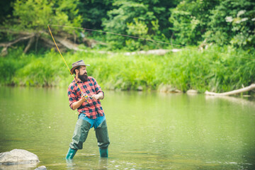 Fisherman man on river or lake with fishing rod.