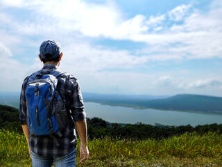 man standing on the mountain adventure tourism mountain climbing back view