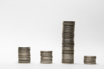 Pile of coins in white background close-up arranged in a row