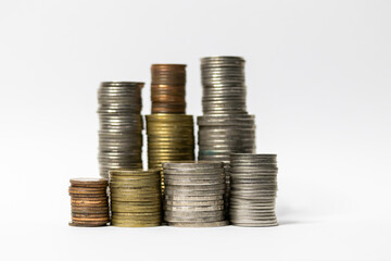 Pile of coins in white background close-up arranged in a row