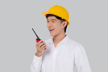Portrait young asian man is engineer wearing helmet standing and using radio for speak with confident isolated on white background, handsome male is architect or contractor, worker or labor concept.