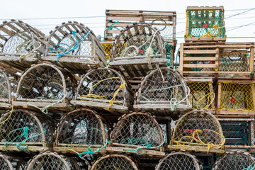 A stack of lobster pots sits on a local wharf out of water waiting for the lobster fishing season...