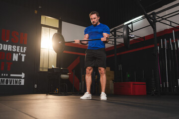 Obraz premium strong athlete man person exercising in modern sport gym, active workout exercise training in fitness studio for body strong power and heavy fit, bodybuilding and physical healthy lifestyle people