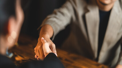 Hands of two male business people shaking hands and sealing a partnership