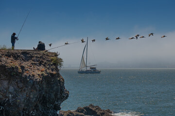 Sailing and fishing off the coast of San Francisco Ca, with fog bank 