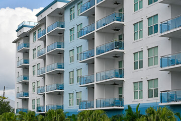 Blue and white ocean inspired colored residential condo with balconies in Florida. 