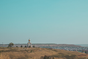 Beautiful landscape of a church on a hill overlooking a small town