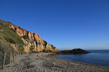 Fototapeta na wymiar Red Bluff, the northern stretch of beach next to it, and the calm waters of Port Phillip Bay