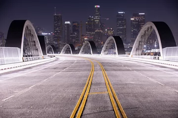 Fototapeten Twilight descends on the 6th Street Bridge as it passes through Downtown Los Angeles, California, USA. © Matt Gush