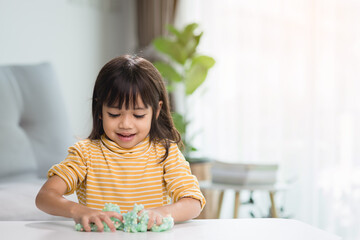 Kid play with handgum. Slime in children hands.