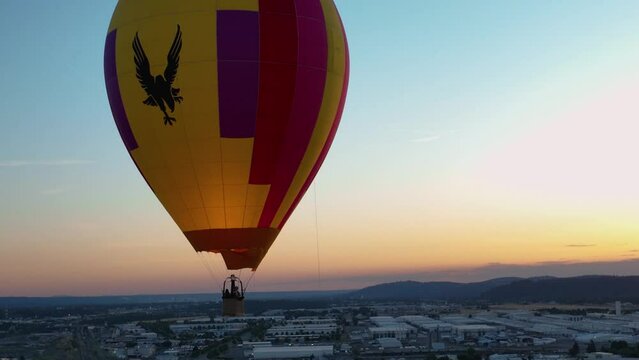 Close Up Shot Of A Hot Air Balloon At Sunset Using Fire To Stay Afloat.