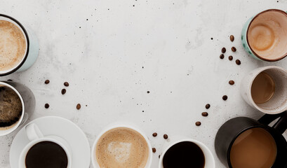 Top view on flat lay with many different full and empty coffee cups composition on gray white concrete background. Variety of tea mug collection layout. Dried coffee beans. Espresso, latte, americano