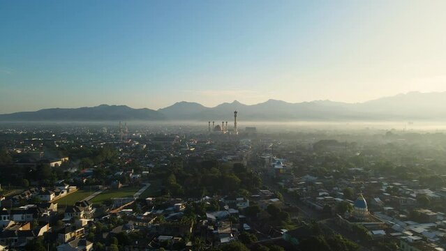 Indonesia, Aerial drone view Mosque Sunny day, blue sky, sunset. Indonesia part of the city, downtown, beautiful mosque in the world