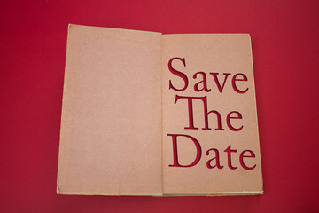 Save The Date word in opened book with vintage, natural patterns old antique paper design.