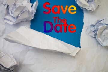 Save The Date text with Torn, Crumpled White Paper on colored background.