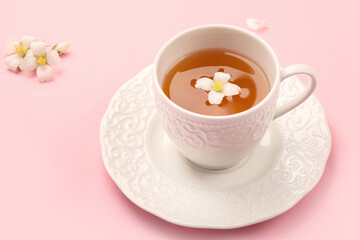 Jasmine tea on color background.