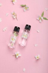 Bottles of essential oil with jasmine flowers.