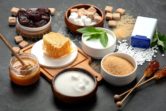 Various diet replacement for sugar on dark background.