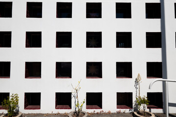 Fototapeta na wymiar Building with grid of windows in white