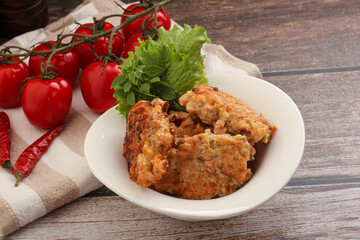 Fried salmonn cutlet in the bowl