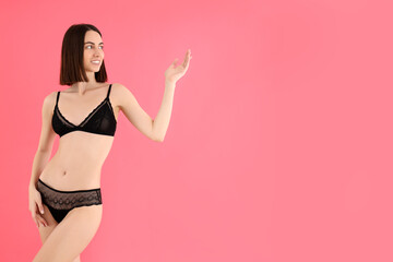 Concept of beauty with slim young woman on pink background