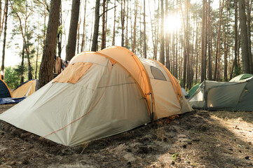 summer camp in the forest. dawn in the forest against the background of a group of tents. wonderful summer vacation in the forest. people sleep in tents