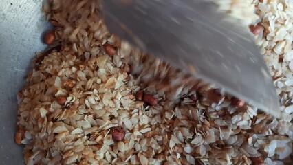 Pohaa and peanut frying in pan. In India, it is eaten with great fervor with tea in the evening. Its other names  pauwa, sira, chira, or avalakki. Traditional snacks of India.
