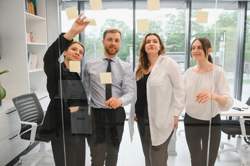 Obraz premium A group of business people partners during a set team meeting in the modern office. Teamwork concept