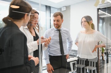 Obraz premium A group of business people partners during a set team meeting in the modern office. Teamwork concept