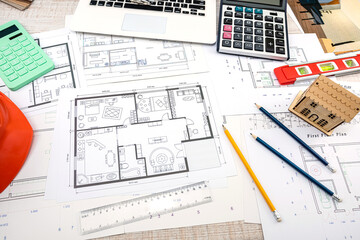 beautiful sketches of drawings for new houses scattered on the table.