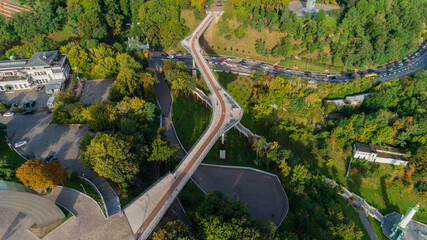 Drone aerial top view beautiful Kyiv pedestrian and bicycle Klitschko bridge on a sunny spring day. Capital of Ukraine 