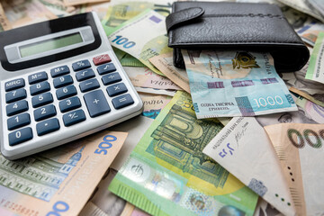 exchange of US dollars to Ukrainian hryvnias on the table with a calculator.