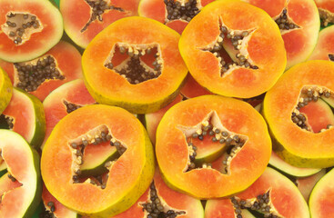 Different sliced papaya fruits as background	