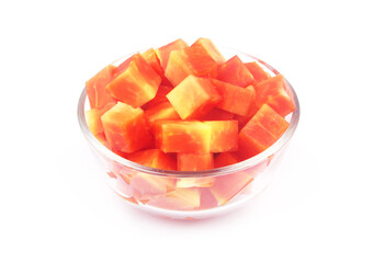 Red papaya fruit slices in glass bowl isolated on white background	